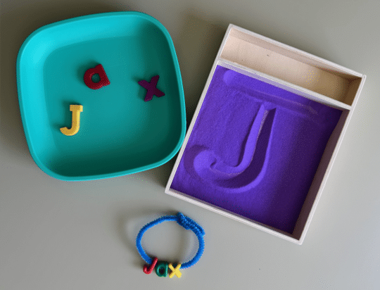 Encourage exploring letters through name activities that are sensory-rich.